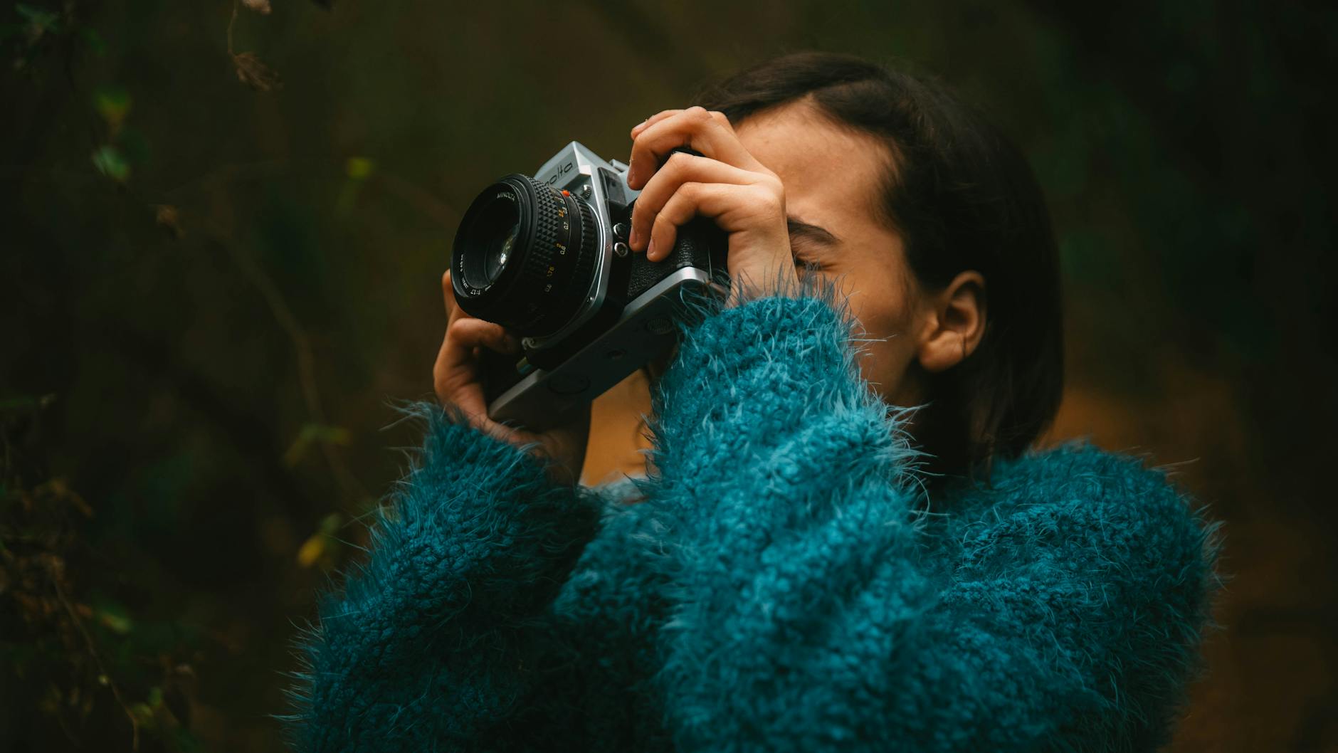 woman taking pictures with vintage camera